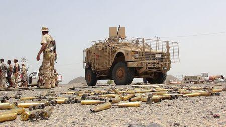 A Southern Resistance fighter walks past an armoured personnel carrier taken by resistance fighters from Houthi fighters in the Emran outskirts of Yemen's southern port city of Aden, July 13, 2015. PHOTO BY REUTERS/Stringer