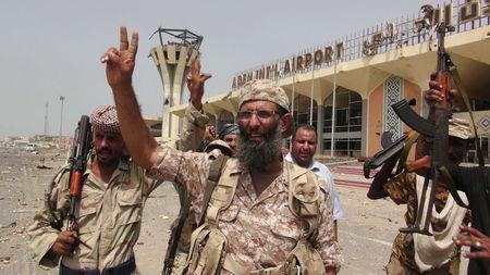 Southern Resistance fighters flash the victory sign at the international airport of Yemen's southern port city of Aden, July 14, 2015. PHOTO BY REUTERS/Stringer