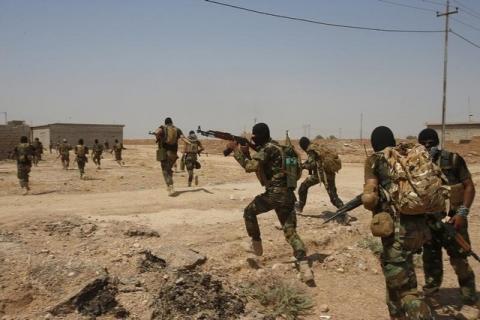 Asaib Ahl al-Haq Shi'ite militia fighters from the south of Iraq run during a mission to take control of Sulaiman Pek village from Islamist State militants, in the northwest of Tikrmt city, September 1, 2014. PHOTO BY REUTERS/Youssef Boudlal