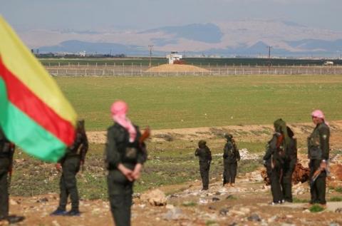 Kurdish members of the Self-Defense Forces stand near the Syrian-Turkish border in the Syrian city of al-Derbasiyah during a protest against the operations launched in Turkey by government security forces against the Kurds, February 9, 2016. PHOTO BY REUTERS/Rodi Said