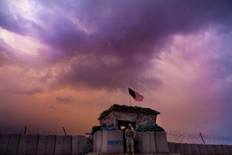 A U.S. Marine from the First Battalion Eighth Marines Alpha Company looks out as an evening storm gathers above an outpost near Kunjak in southern Afghanistan's Helmand province, February 22, 2011. PHOTO BY REUTERS/Finbarr O'Reilly