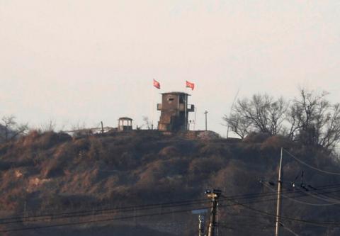 A North Korean flag flutters on the top of their guard post inside North Korean territory in this picture taken near the demilitarized zone separating the two Koreas in Paju, South Korea. PHOTO BY REUTERS/Kim Hong-Ji