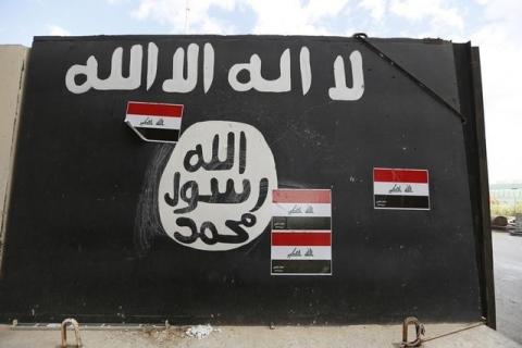A wall painted with the black flag commonly used by Islamic State militants, near former Iraqi president Saddam Hussein's palace in Tikrmt, April 1, 2015. PHOTO BY REUTERS/Thaier Al-Sudani