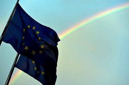 A rainbow is seen behind European flags during a euro zone EU leaders emergency summit at the European Council headquarters in Brussels, Belgium, July 7, 2015. PHOTO BY REUTERS/Eric Vidal