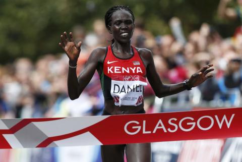 Kenya's Flomena Cheyech Daniel crosses the finish line to win the women's marathon gold medal at the 2014 Commonwealth Games in Glasgow, Scotland