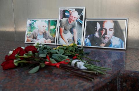 Photographs of journalists, (R-L) Orhan Dzhemal, Kirill Radchenko and Alexander Rastorguyev, who were recently killed in Central African Republic by unidentified assailants, are on display outside the Central House of Journalists in Moscow, Russia, August 1, 2018. PHOTO BY REUTERS/Maxim Shemetov