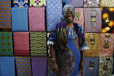 Fofanan Man, a 59-year-old businesswoman, poses for a photograph in front of textiles in her shop in Bouake, Ivory Coast, February 10, 2016. PHOTO BY REUTERS/Thierry Gouegnon