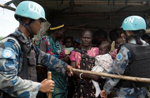 United Nations peacekeepers control South Sudanese women and children before the distribution of emergency food supplies at the United Nations protection of civilians (POC) site 3 hosting about 30,000 people displaced during the recent fighting in Juba, South Sudan, July 25, 2016. PHOTO BY REUTERS/Adriane Ohanesian
