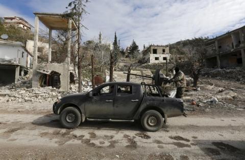 Forces loyal to Syria's President Bashar al-Assad drive a vehicle mounted with an anti-aircraft weapon in the town of Rabiya after they recaptured the rebel-held town in coastal Latakia province, Syria, January 27, 2016. PHOTO BY REUTERS/Omar Sanadiki