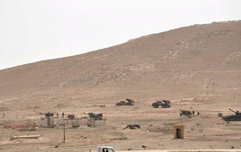 Forces loyal to Syria's President Bashar al-Assad stand near their weapons during their offensive to recapture the historic city of Palmyra in this picture provided by SANA on March 24, 2016. PHOTO BY REUTERS/SANA