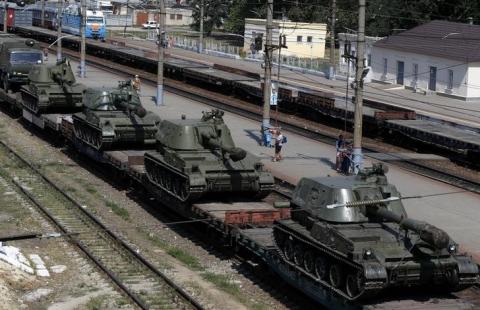 A freight car loaded with self-propelled howitzers is seen at a railway station in Kamensk-Shakhtinsky, Rostov region, near the border with Ukraine