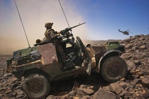 A French soldier stands guard in an armoured vehicle , about 60 km (37 miles) south of the town of Tessalit in northern Mali, March 21, 2013. PHOTO BY REUTERS/Francois Rihouay