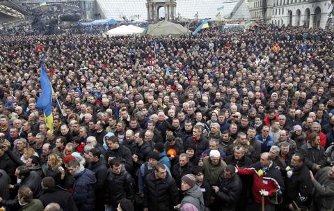 People attend the funeral service for two anti-governent protesters who were killed after days of violence in Kiev