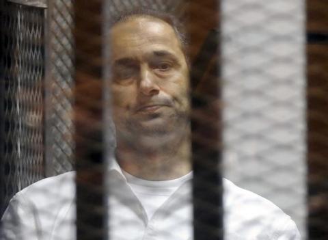 Gamal Mubarak, son of former Egyptian President Hosni Mubarak, reacts inside a cage in a courtroom at the police academy, Cairo May 21, 2014. PHOTO BY REUTERS/Stringer