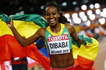 Genzebe Dibaba of Ethiopia holds her national flag after winning the women's 1500 metres final at the 15th IAAF World Championships at the National Stadium in Beijing, China, August 25, 2015. PHOTO BY REUTERS/Kai Pfaffenbach