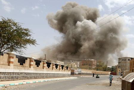 A girl runs for shelter during an air strike in Sanaa, April 8, 2015. PHOTO BY REUTERS/Khaled Abdullah
