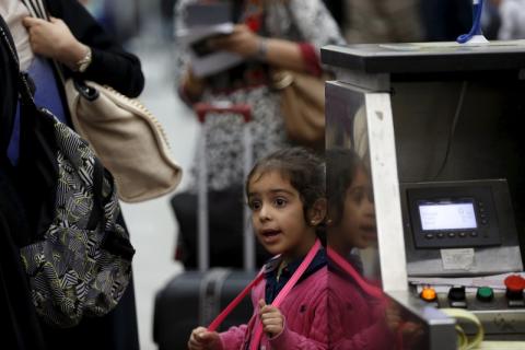 A girl waits with her family for their flight at the Sanaa Airport, March 28, 2015. PHOTO BY REUTERS/Khaled Abdullah