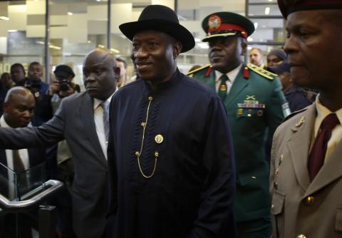 Nigeria's President Goodluck Jonathan (C) arrives for the service for former South African President Nelson Mandela at the First National Bank Stadium, in Johannesburg