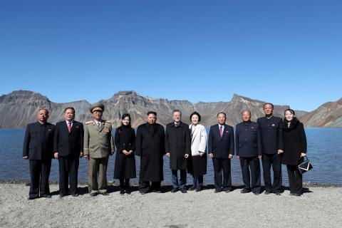 South Korean President Moon Jae-in, first lady Kim Jung-sook, North Korean leader Kim Jong Un and his wife Ri Sol Ju pose for photographs with North Korean aides beside the Heaven Lake of Mt. Paektu, North Korea, September 20, 2018. PHOTO BY REUTERS/Pyeongyang Press Corps