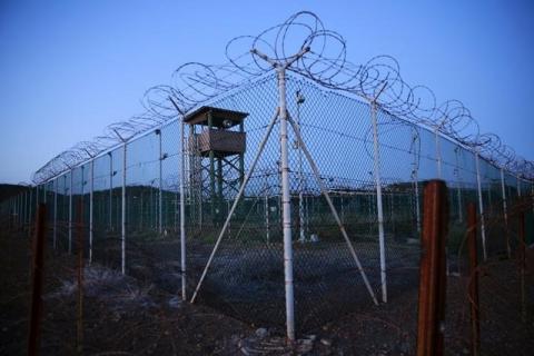 Chain link fence and concertina wire surrounds a deserted guard tower within Joint Task Force Guantanamo's Camp Delta at the U.S. Naval Base in Guantanamo Bay, Cuba, March 21, 2016. PHOTO BY REUTERS/Lucas Jackson
