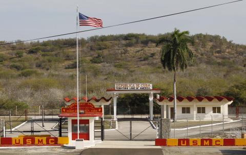 The Northeast gate marks the end of U.S. soil as the road leads into Cuba at Guantanamo Bay U.S. Naval Base, March 8, 2013. PHOTO BY REUTERS/Bob Strong