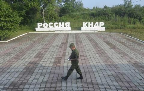 A guard walks along the platform at the border crossing between Russia and North Korea at the North Korean settlement of Tumangan July 18, 2014. The signage reads, "Russia" and "KNDR (Democratic People's Republic of Korea)". PHOTO BY REUTERS/Yuri Maltsev