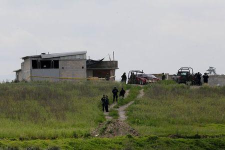 Policemen guard the site where a tunnel, connected to the Altiplano Federal Penitentiary and used by drug lord Joaquin 'El Chapo' Guzman to escape, was located in Almoloya de Juarez, on the outskirts of Mexico City, July 12, 2015. PHOTO BY REUTERS/Tomas Bravo