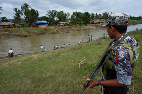 A Myanmar border guard police officer stands guard in Tin May village, Buthidaung township, northern Rakhine state, Myanmar, July 14, 2017. PHOTO BY REUTERS/Simon Lewis