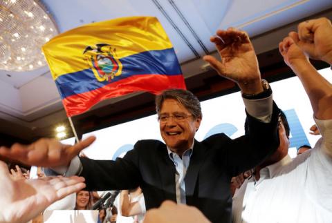Guillermo Lasso (C), presidential candidate from the CREO party, celebrates with supporters after early election tally suggests a runoff between him and candidate of the ruling PAIS Alliance Party Lenin Moreno (not pictured), in Guayaquil, Ecuador, February 19, 2017. PHOTO BY REUTERS/Henry Romero