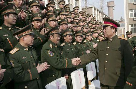 China's Central Military Commission former Vice Chairman General Guo Boxiong shakes hands with military officers in Shijiazhuang, Hebei province, China, February 1, 2007. PHOTO BY REUTERS/Stringer
