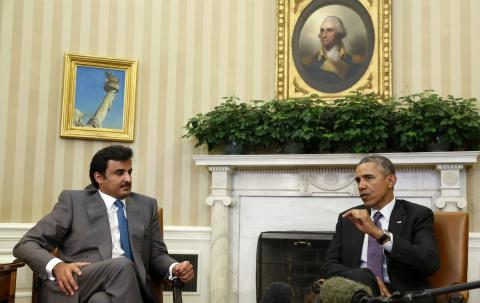 U.S. President Barack Obama meets with Emir of Qatar Sheikh Tamim bin Hamad al Thani while in the Oval Office at the White House in Washington, February 24, 2015. PHOTO BY REUTERS/Larry Downing
