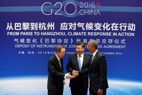 Chinese President Xi Jinping (C), UN Secretary General Ban Ki-moon and U.S. President Barack Obama (R) shake hands during a joint ratification of the Paris climate change agreement ceremony ahead of the G20 Summit at the West Lake State Guest House in Hangzhou, China, September 3, 2016. PHOTO BY REUTERS/How Hwee Young