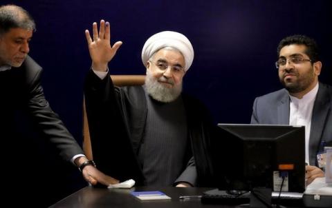 Iranian President Hassan Rouhani (C) waves after he registered for February's election of the Assembly of Experts, the clerical body that chooses the supreme leader, at the Interior Ministry in Tehran, December 21, 2015. PHOTO BY REUTERS/Raheb Homavandi