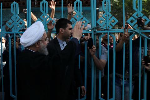 Iran's President Hassan Rouhani waves to supporters at a polling station during the presidential election in Tehran, Iran, May 19, 2017. PHOTO BY REUTERS/President.ir