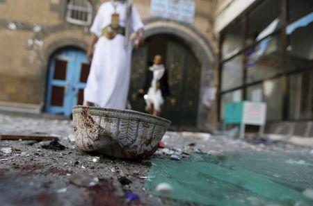 People walk past a headgear lying on the ground at the al-Balili mosque after two bombings at the mosque in Yemen's capital Sanaa, September 24, 2015. PHOTO BY REUTERS/Khaled Abdullah