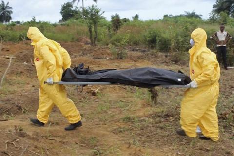 Health workers carry the body of an Ebola virus victim in the Waterloo district of Freetown, October 21, 2014. PHOTO BY REUTERS/Josephus Olu-Mamma