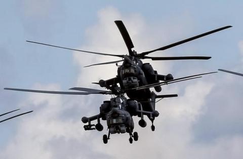 Russian Mi-28Ns from the Berkuty (Golden Eagles) helicopter display team fly in formation during the Aviadarts military aviation competition at the Dubrovichi range near Ryazan, Russia, August 2, 2015. PHOTO BY REUTERS/Maxim Shemetov