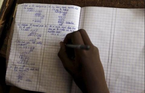A pupil revises his class work in Kenya's capital Nairobi, September 9, 2015. PHOTO BY REUTERS/Thomas Mukoya