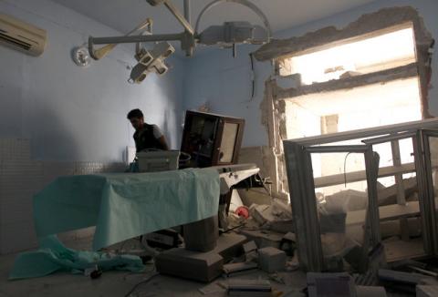 A medic inspects the damage inside Anadan Hospital, sponsored by Union of Medical Care and Relief Organizations (UOSSM), after it was hit yesterday by an airstrike in the rebel held city of Anadan, northern Aleppo province, Syria, July 31, 2016. PHOTO BY REUTERS/Ammar Abdullah