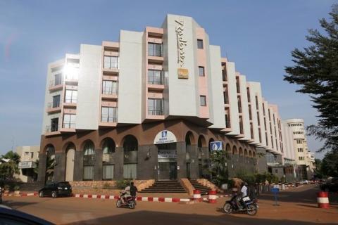 People drive motorcycles past the Radisson Blu hotel in Bamako, Mali, November 22, 2015. PHOTO BY REUTERS/Joe Penney