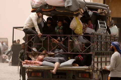 Internally displaced people who fled Raqqa city ride a vehicle with their belongings in a camp near Ain Issa, Raqqa Governorate, Syria, May 19, 2017. PHOTO BY REUTERS/Rodi Said