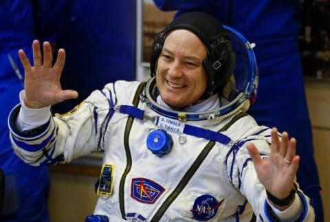 The International Space Station (ISS) crew member Scott Tingle of the U.S. waves during his space suit check shortly before his launch at the Baikonur Cosmodrome, Kazakhstan, December 17, 2017. PHOTO BY REUTERS/Shamil Zhumatov