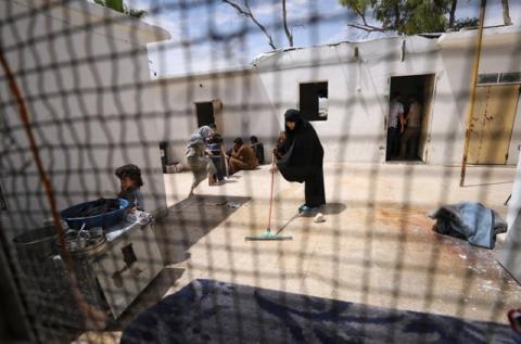 Tunisian Iman Othman, wife of a former Islamic State fighter, cleans the floor at a camp for displaced people in Ain Issa, north of Raqqa, Syria, June 21, 2017. PHOTO BY REUTERS/Rodi Said
