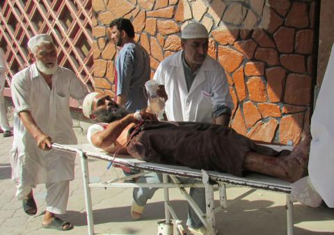 Afghan men carry an injured man to a hospital after a suicide attack in Nangarhar province, Afghanistan, September 11, 2018. PHOTO BY REUTERS/Stringer