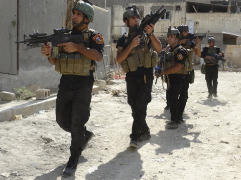 Members of the Iraqi Special Operations Forces (ISOF) conduct a patrol looking for militants of the Islamic State, formerly known as the Islamic State in Iraq and the Levant (ISIL), in a neighbourhood in Ramadi
