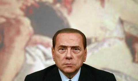 Italy's Prime Minister Silvio Berlusconi looks on during a news conference at Chigi Palace in Rome