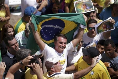 Congressman Jair Bolsonaro holds a Brazilian flag during a protest against Brazil's President Dilma Rousseff, part of nationwide protests calling for her impeachment, in Brasilia, Brazil, March 13, 2016. PHOTO BY REUTERS/Ueslei Marcelino