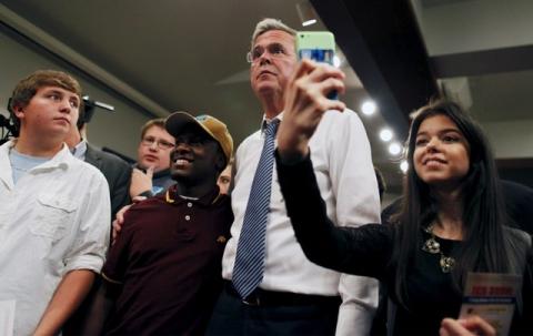 U.S. Republican presidential candidate and former Florida Governor Jeb Bush (C) poses for cell phone photos with students after a town hall meeting at Coastal Carolina University in Conway, South Carolina, November 17, 2015. PHOTO BY REUTERS/Randall Hill