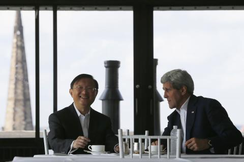 China's State Councillor Yang Jiechi (L) and U.S. Secretary of State John Kerry talk over tea during a day of meetings in Boston, Massachusetts