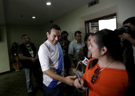 Guatemalan presidential candidate Jimmy Morales of the National Convergence Front greets a journalist after a news conference in Guatemala City, September 7, 2015. PHOTO BY REUTERS/Jorge Dan Lopez